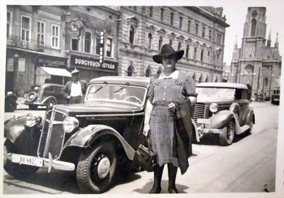 A woman beside a parked car, Liberty Square, Novi Sad, 1942