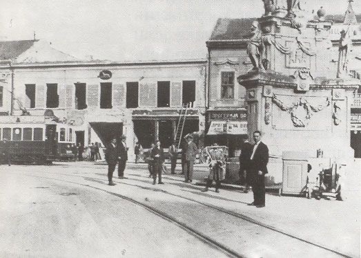 Men standing at the column base, Liberty Square, Novi Sad, 1911–1947